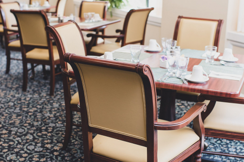 Dining area with tables and chairs arranged elegantly at Charlesgate Senior Living Center