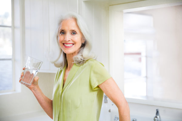 Senior woman drinking a glass of water