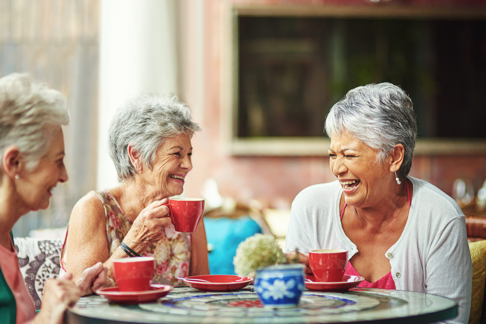A group of elderly friends having coffee together