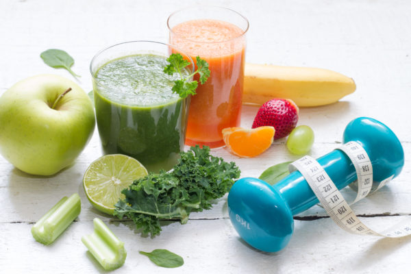 Fruits, vegetables, juice, smoothie and dumbbell