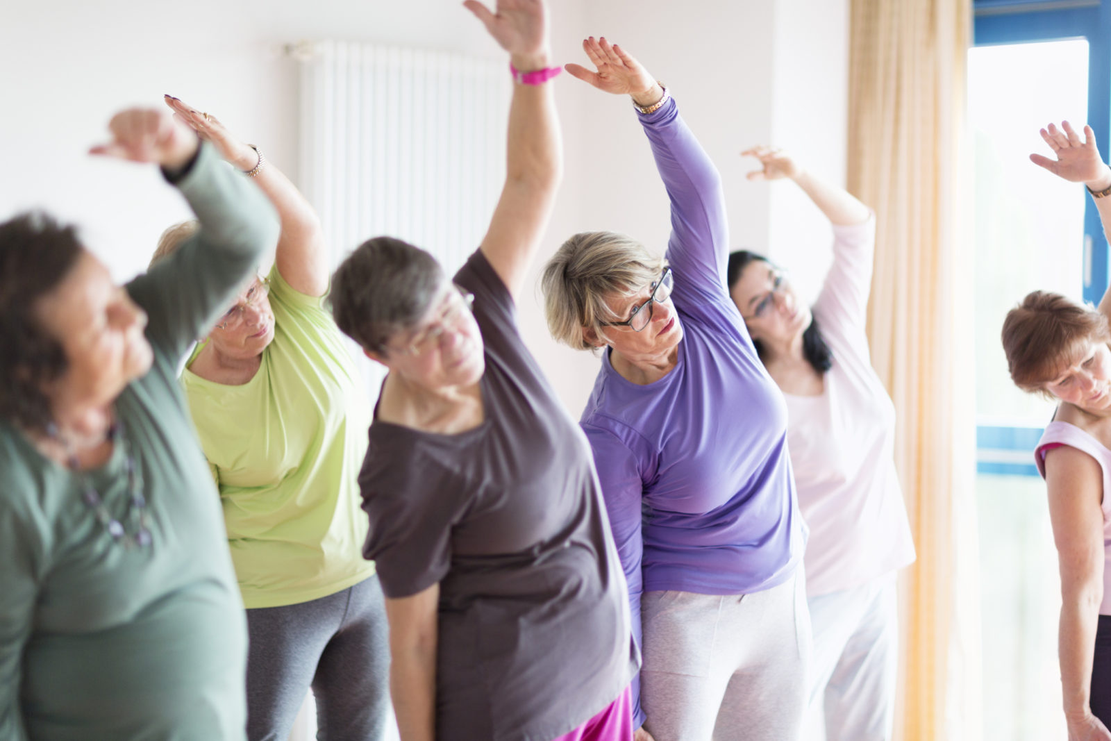 a group of senior women in a stretching class