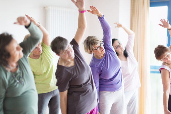 a group of senior women in a stretching class