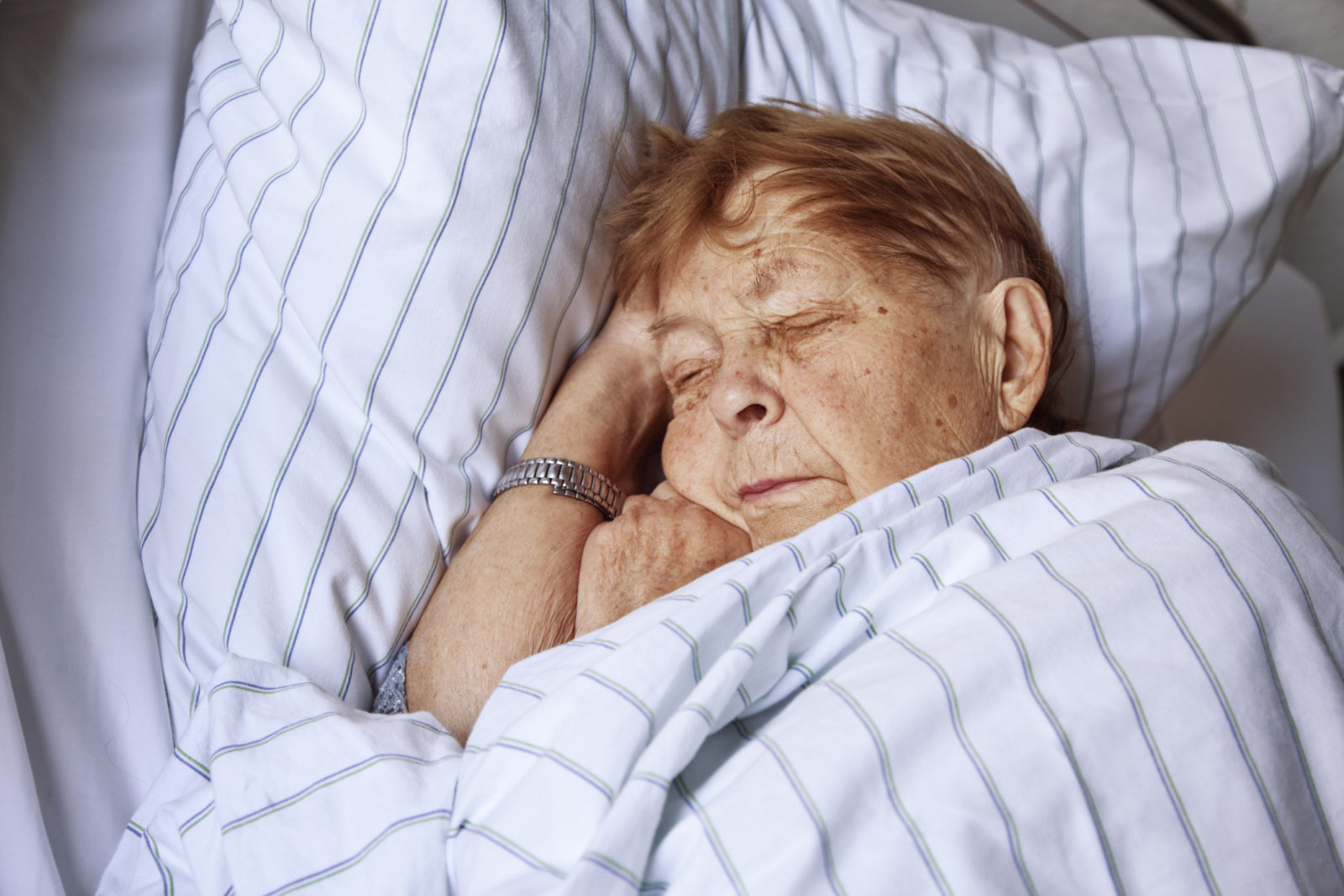 senior woman asleep in bed