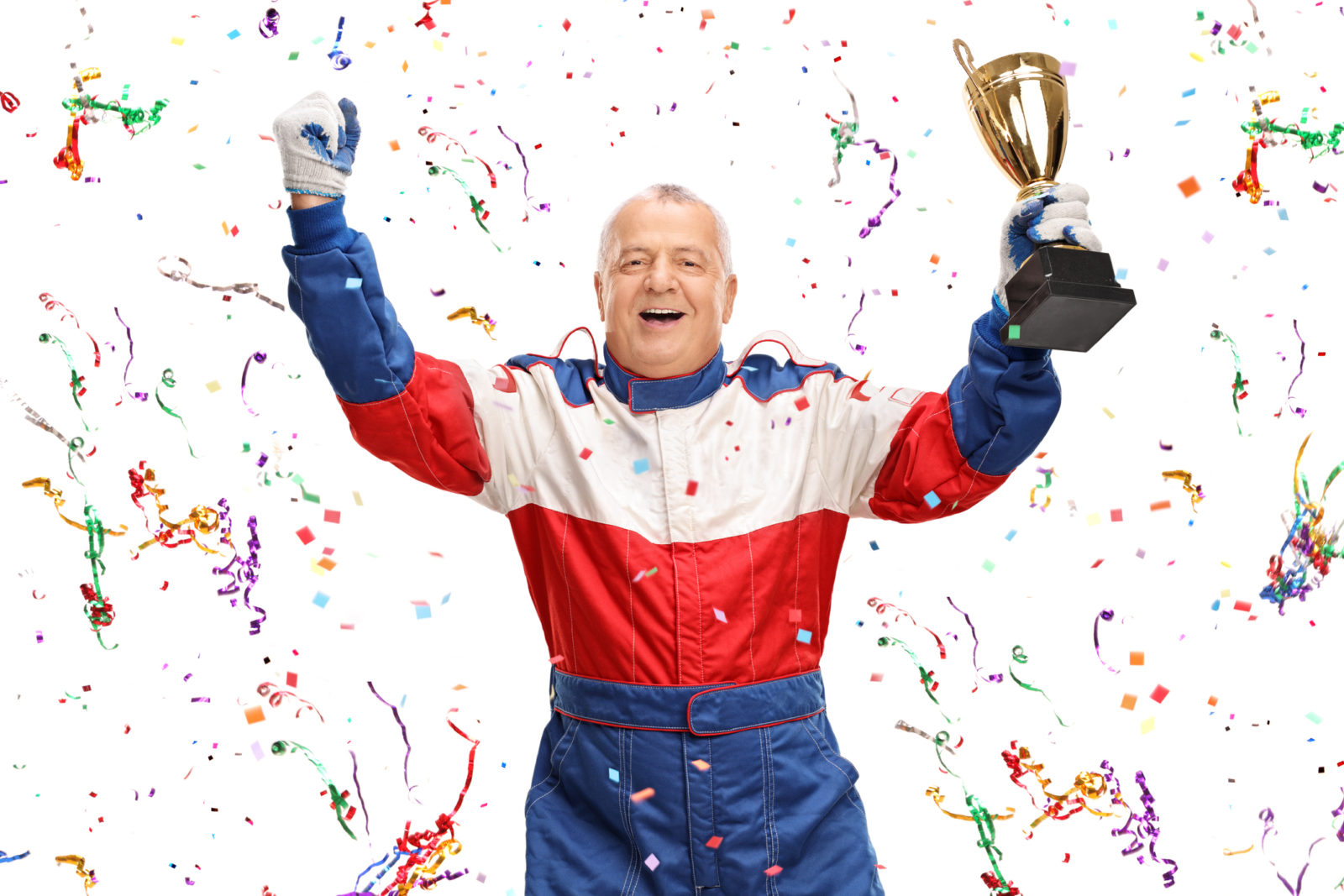 Elder man holding trophy and being showered by confetti