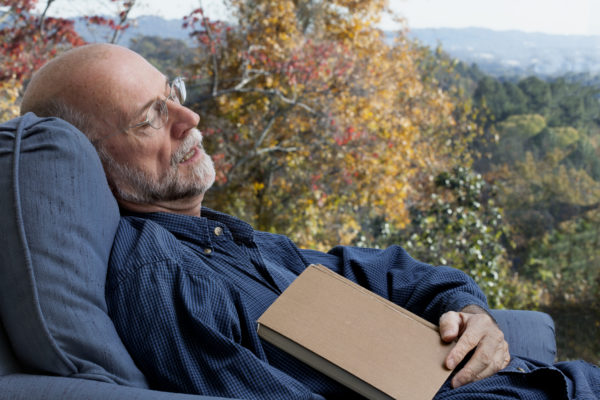 A 62-year-old man who fell asleep in while reading a book on a sunny autumn day.