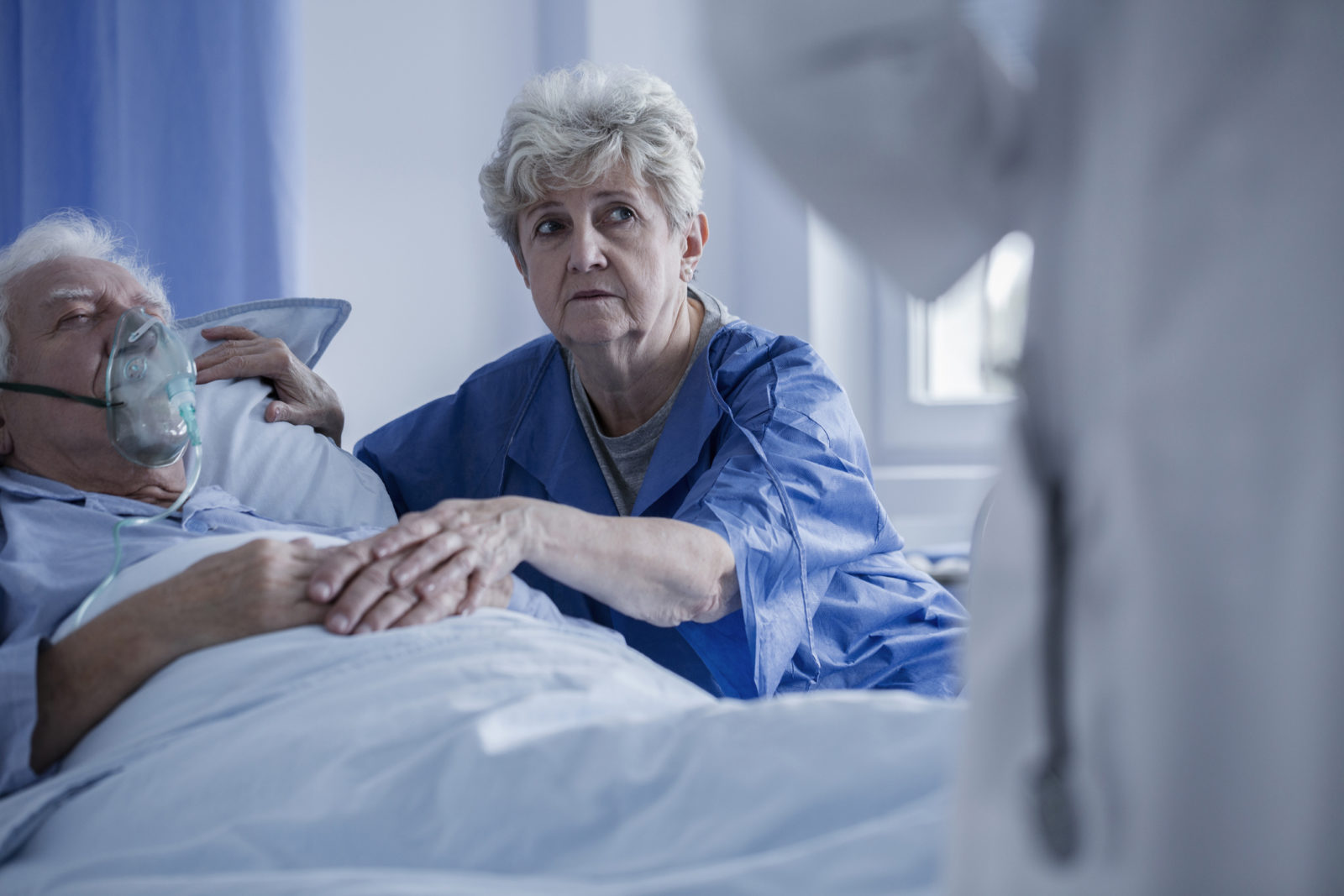 elderly man in hospital with wife by his side talking to doctor