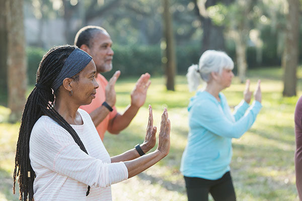 older adults doing tai chi in the park