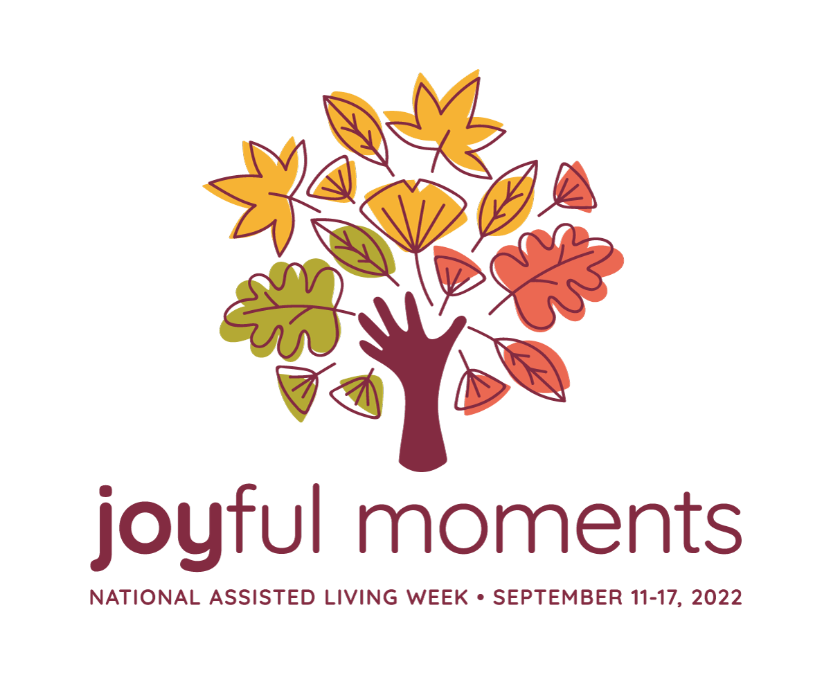 A hand throws up colorful fall leaves with the effect that it looks like a tree trunk with fall leaves on it. Below reads joyful moments national assisted living week september 11-17, 2022