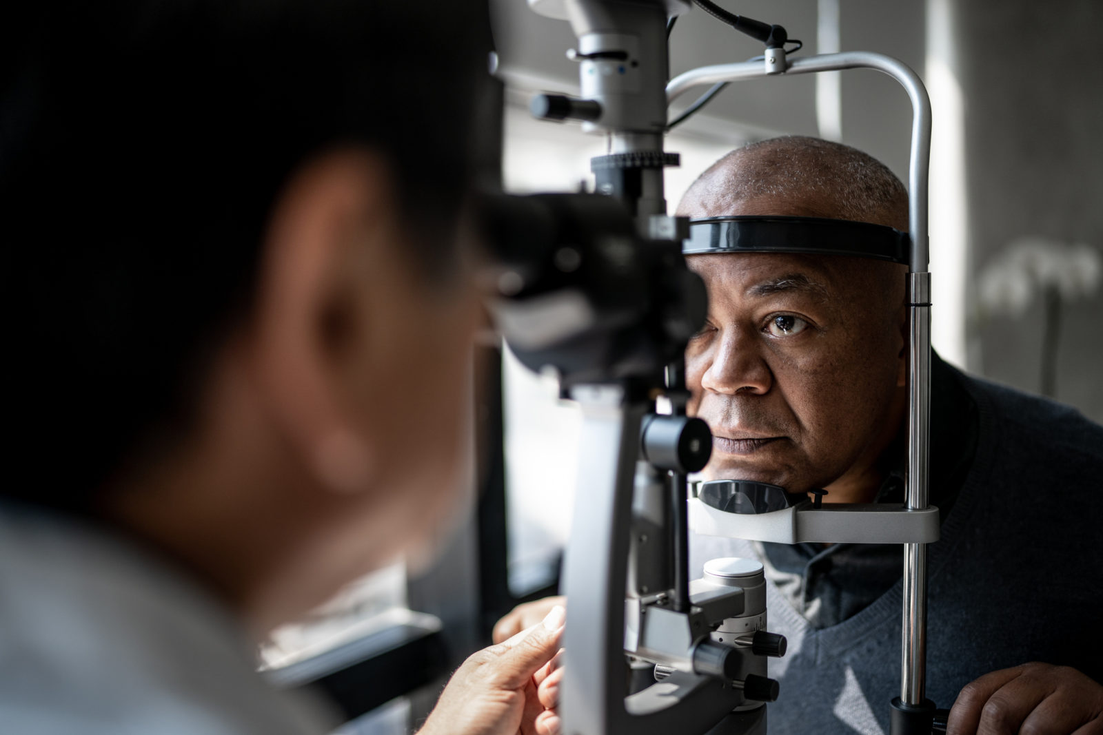 Ophthalmologist examining Black patient's eyes